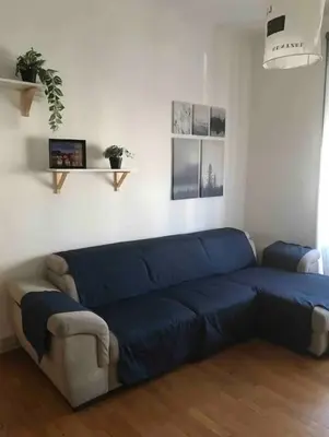 a blue couch sitting in a living room at Appartamento 5 stelle in Piazza Asti - Re di Roma - in Rome