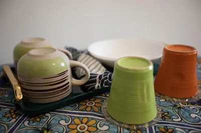 a group of cups and plates sitting on a table at Stanza da Apollo e Diana in Rome