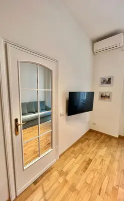 a living room with a window and a tv at Civitas Leonina Apartment in Rome