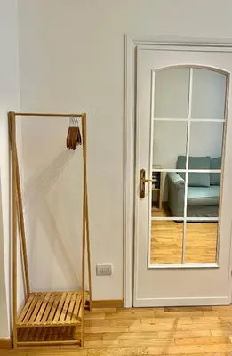 a room with a mirror and a bench next to a door at Civitas Leonina Apartment in Rome