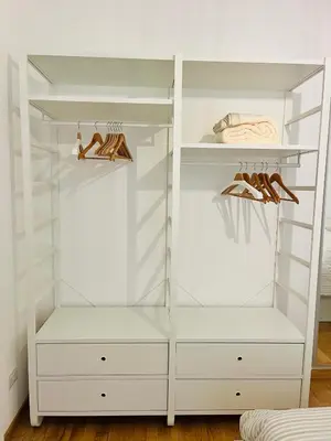 a white walk in closet with shoes in it at Civitas Leonina Apartment in Rome