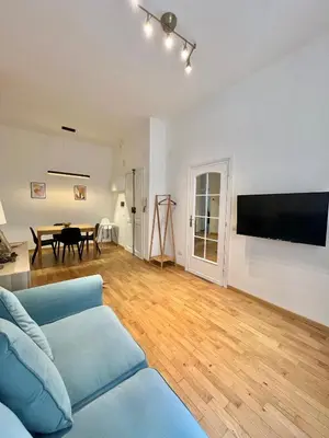 a living room with a blue couch and a table at Civitas Leonina Apartment in Rome