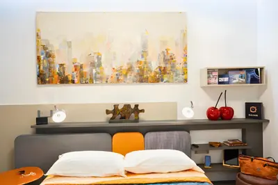 a bedroom with a bed and a painting on the wall at The Best Nest - Home Suite Home NEW OPENING in Rome