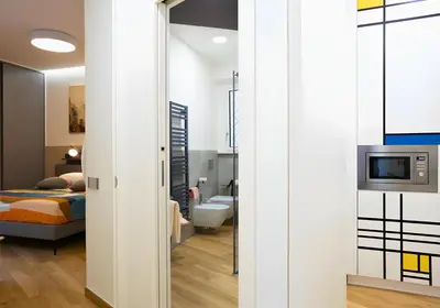 a room with a bedroom and a bed and a tv at The Best Nest - Home Suite Home NEW OPENING in Rome