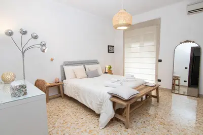 a bedroom with a bed and a table and a mirror at Mia Ginger, Stazione Trastevere vicinanze in Rome