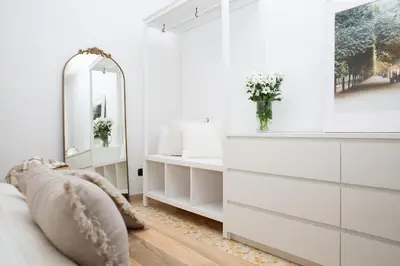 a bedroom with white furniture and a mirror at Mia Ginger, Stazione Trastevere vicinanze in Rome