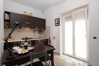 a kitchen with a table with a lamp on it at Mia Ginger, Stazione Trastevere vicinanze in Rome