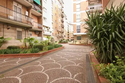 an empty courtyard with plants in a building at Mia Ginger, Stazione Trastevere vicinanze in Rome
