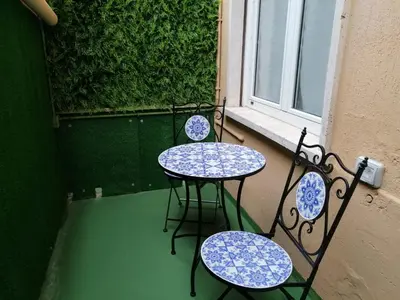 two tables and chairs on a balcony with a window at San Pietro Happy Home in Rome