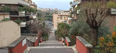 a stairway leading down a city street with buildings at San Pietro Happy Home in Rome