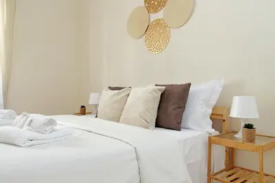 a bedroom with a bed with white sheets and pillows at A Casa di Domenico in Rome