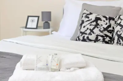a bed with white towels on it with a pillow at A Casa di Domenico in Rome