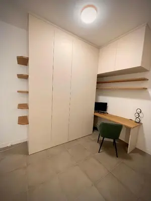 a room with a desk and a green chair at Sweet RHome - A due passi da San Pietro in Rome