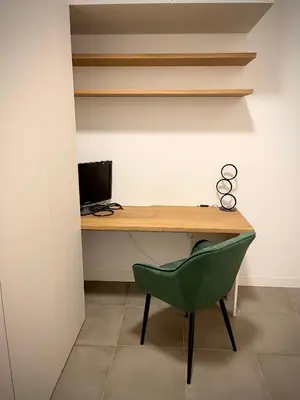 a desk with a green chair and a computer at Sweet RHome - A due passi da San Pietro in Rome