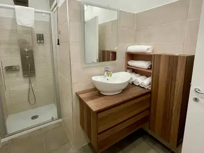 a bathroom with a sink and a shower at Sweet RHome - A due passi da San Pietro in Rome