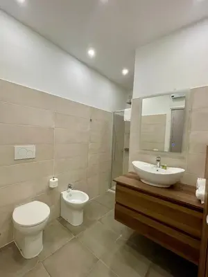 a bathroom with a toilet and a sink and a mirror at Sweet RHome - A due passi da San Pietro in Rome