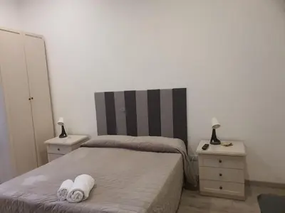 a bedroom with two beds and two night stands at Casa Max in Rome