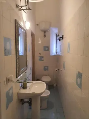 a bathroom with a sink and a toilet and a mirror at Casa Max in Rome