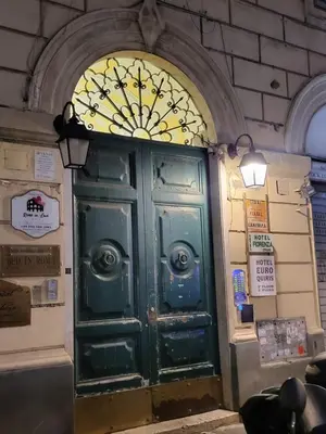 a green door in a building with a window at Casa Max in Rome