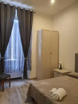 a bedroom with a bed and a large window at Casa Max in Rome