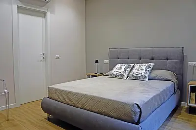 a bedroom with a large bed with two pillows on it at Pinciano 1stfloor in Rome