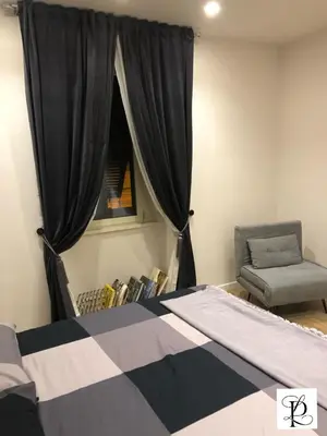 a bedroom with a bed and a window and a chair at Pinciano 1stfloor in Rome