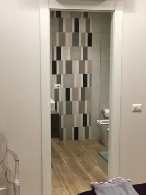 a bathroom with a toilet and a glass door at Pinciano 1stfloor in Rome
