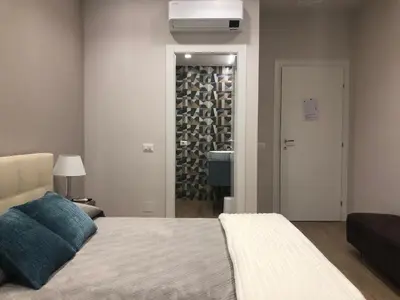 a bedroom with a bed and a wall of wine bottles at Pinciano 1stfloor in Rome