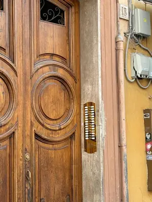 a wooden door on the side of a building at A casa di Ala in Rome