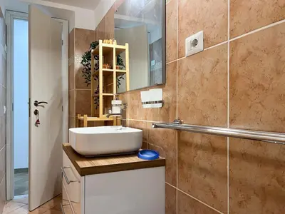 a bathroom with a sink and a mirror at A casa di Ala in Rome