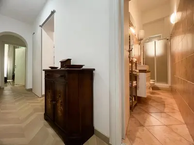 a hallway with a wooden cabinet in a room at A casa di Ala in Rome