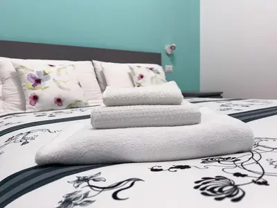 two beds with towels stacked on top of each other at A casa di Ala in Rome