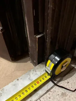a measuring tool and a measuring tape next to a door at A casa di Ala in Rome