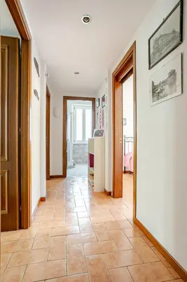 a hallway with a tile floor in a house at Rome artist house in Rome