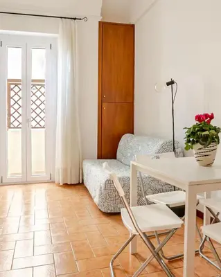 a living room with a table and a couch at Rome artist house in Rome
