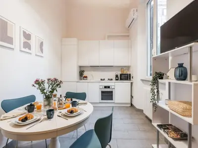 a kitchen and dining room with a table and chairs at The Best Rent - Three-Bedroom apartment in Manzoni district in Rome