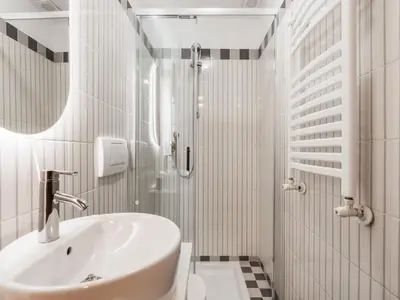 a white bathroom with a sink and a shower at The Best Rent - Three-Bedroom apartment in Manzoni district in Rome