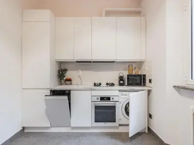 a white kitchen with white cabinets and a dishwasher at The Best Rent - Three-Bedroom apartment in Manzoni district in Rome