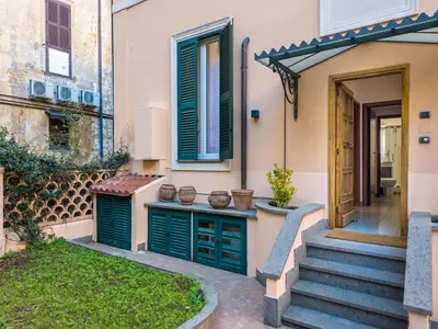 a house with green doors and a stairway at The Best Rent - Three-Bedroom apartment in Manzoni district in Rome