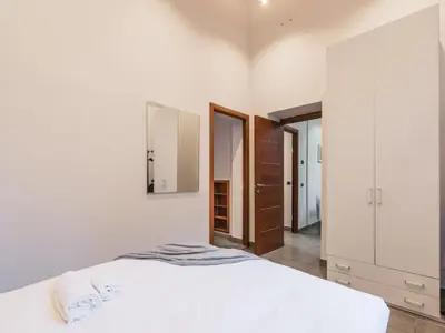 a bedroom with a white bed and a mirror at The Best Rent - Three-Bedroom apartment in Manzoni district in Rome