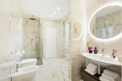 a white bathroom with a sink and a mirror at Terrace Boutique Apartment - Dolce Vita in Rome