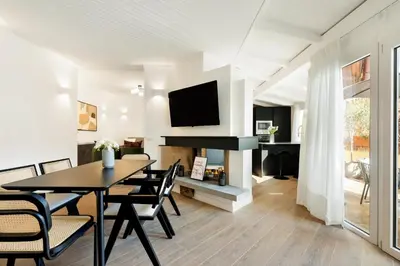 a dining room with a table and a fireplace at Terrace Boutique Apartment - Dolce Vita in Rome