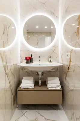 a bathroom with a sink and two mirrors at Terrace Boutique Apartment - Dolce Vita in Rome