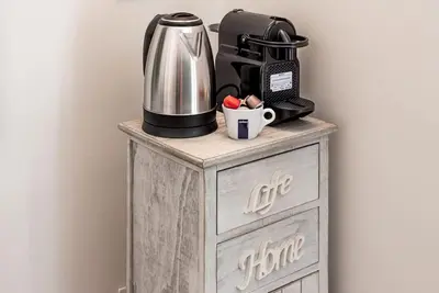 a coffee maker on top of a wooden cabinet at Lungaretta Studio Flat [trastevere] in Rome