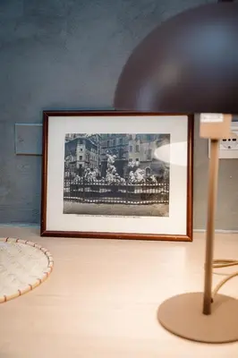 a picture on top of a table with a lamp at Maison Macao - Golden Keys Collection in Rome