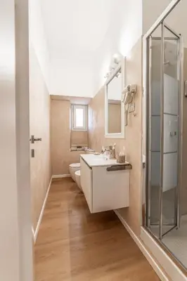 a bathroom with a sink and a mirror at Maison Macao - Golden Keys Collection in Rome