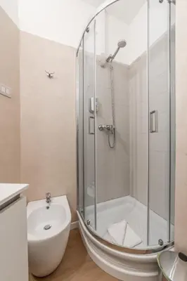 a bathroom with a shower and a toilet and a sink at Maison Macao - Golden Keys Collection in Rome
