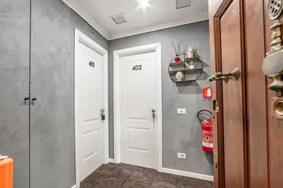 a hallway with two white doors and a fire hydrant at Maison Macao - Golden Keys Collection in Rome