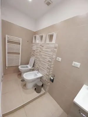 a bathroom with a toilet and a sink at Il covo dei Briganti in Rome