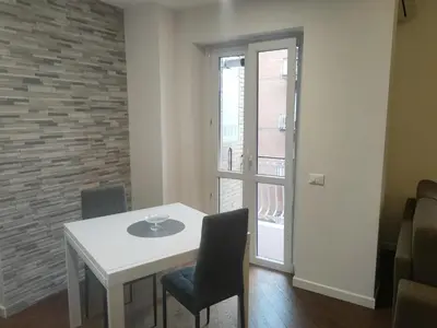 a white table and chairs in a room with a window at Il covo dei Briganti in Rome